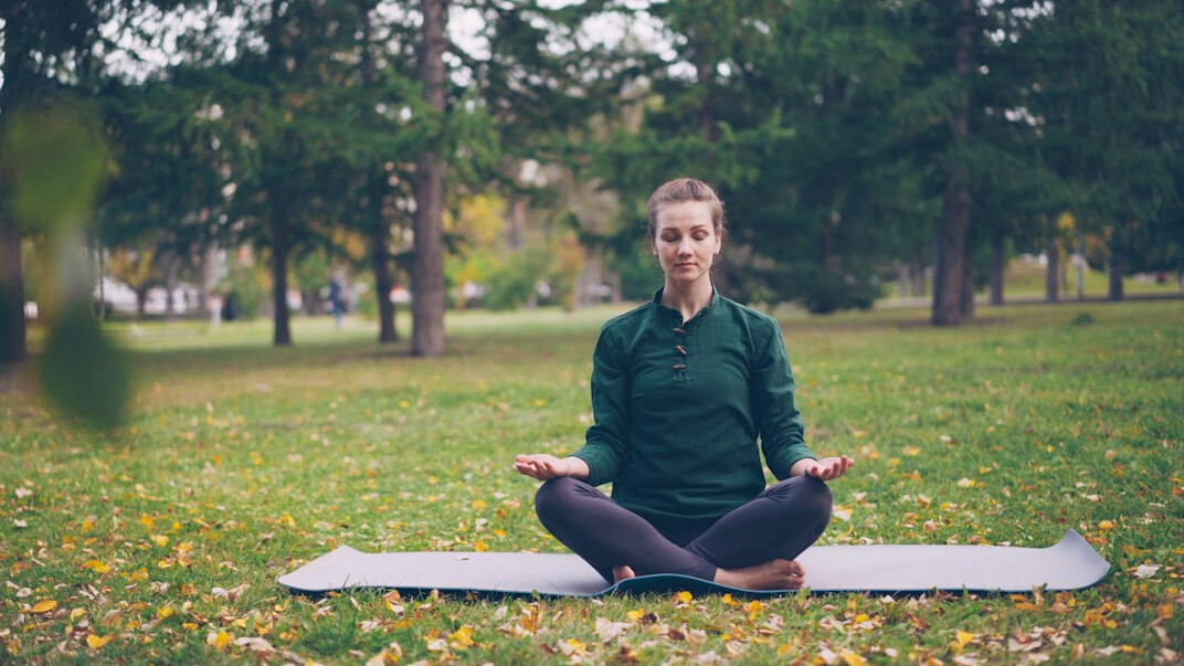 woman doing yoga in park